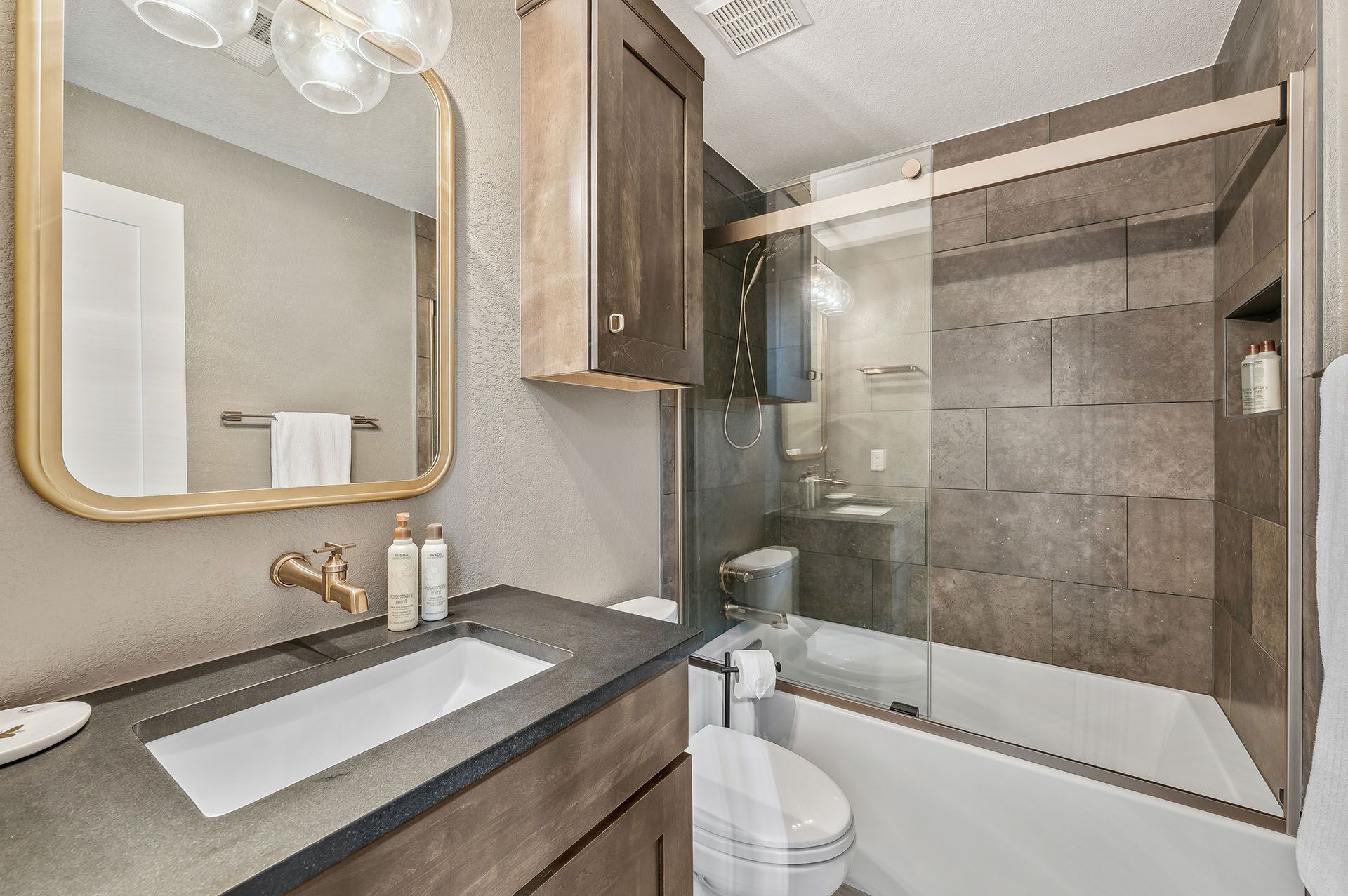 A bathroom with a sink, toilet, and shower