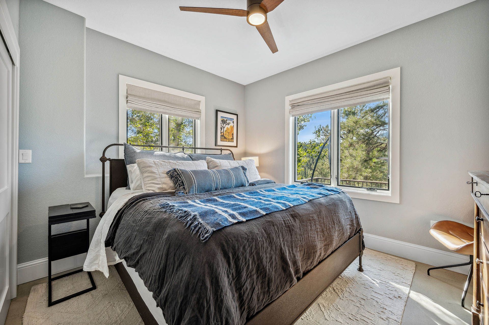 A bedroom with a king size bed and a ceiling fan