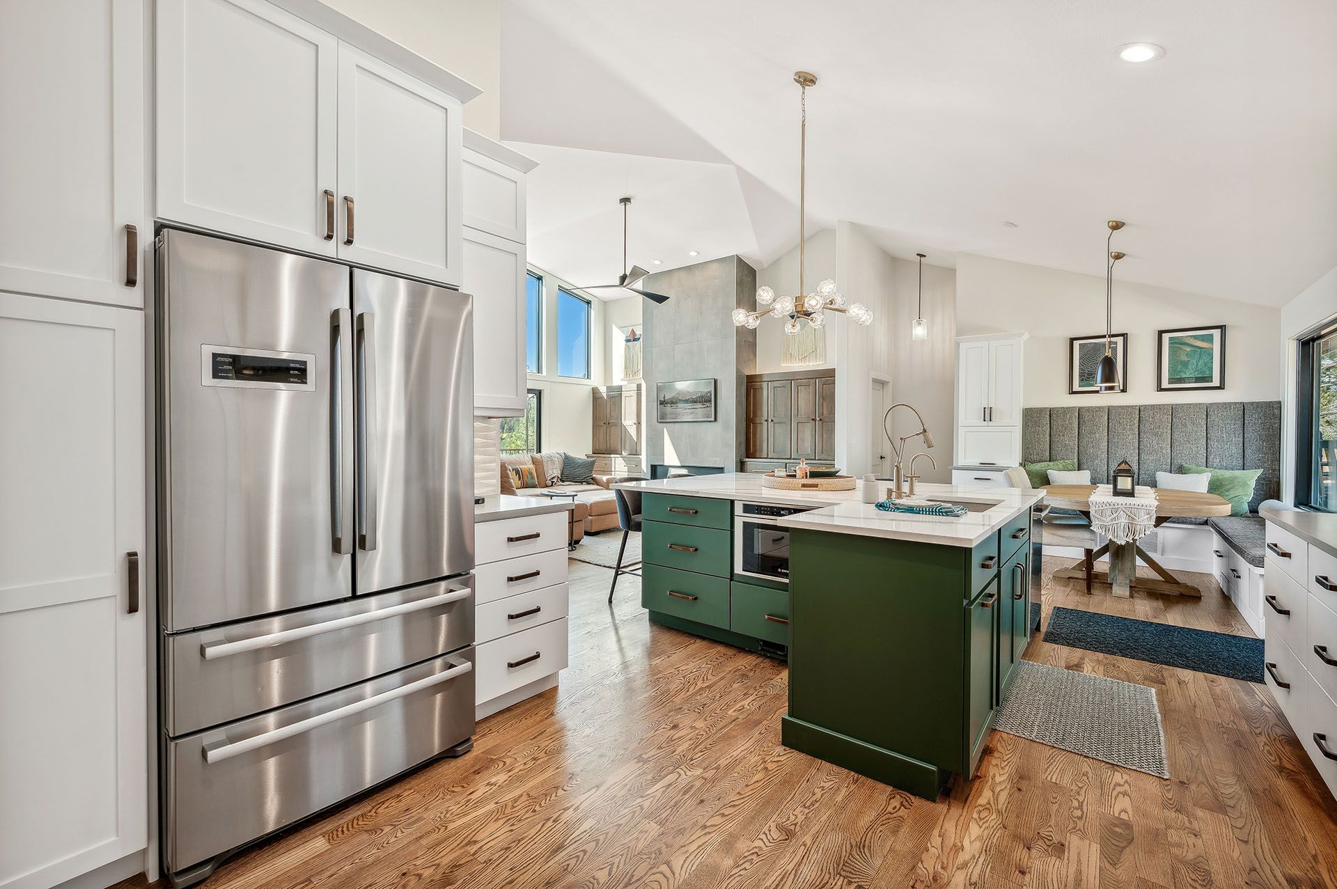 A kitchen with stainless steel appliances and green cabinets