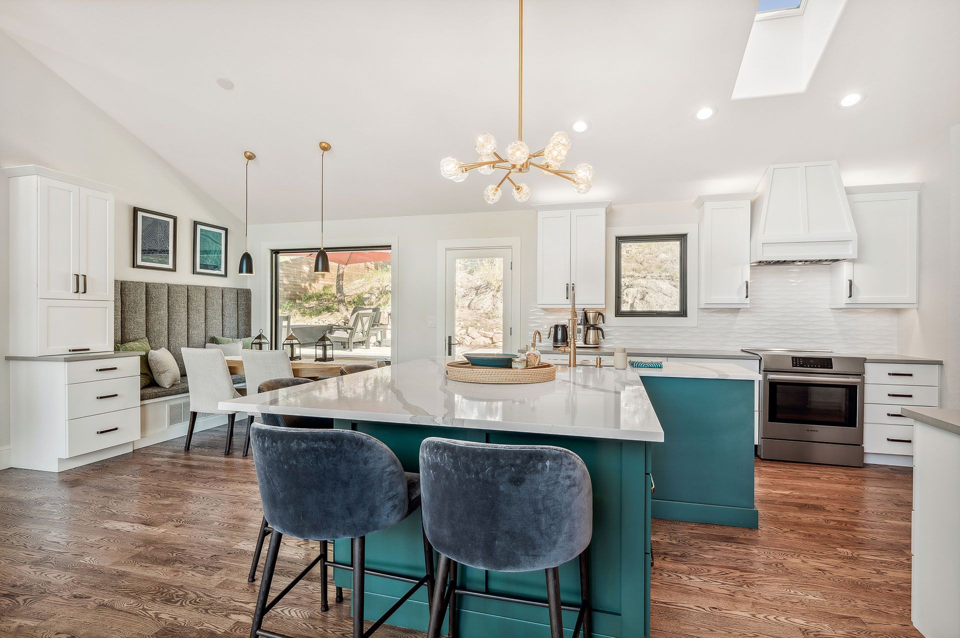 A kitchen with a large island and stools in it