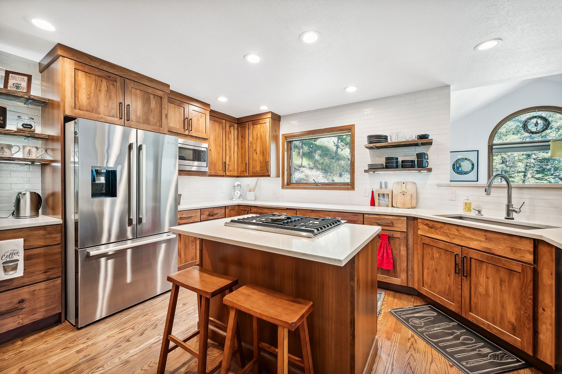 A kitchen with stainless steel appliances and wooden cabinets.