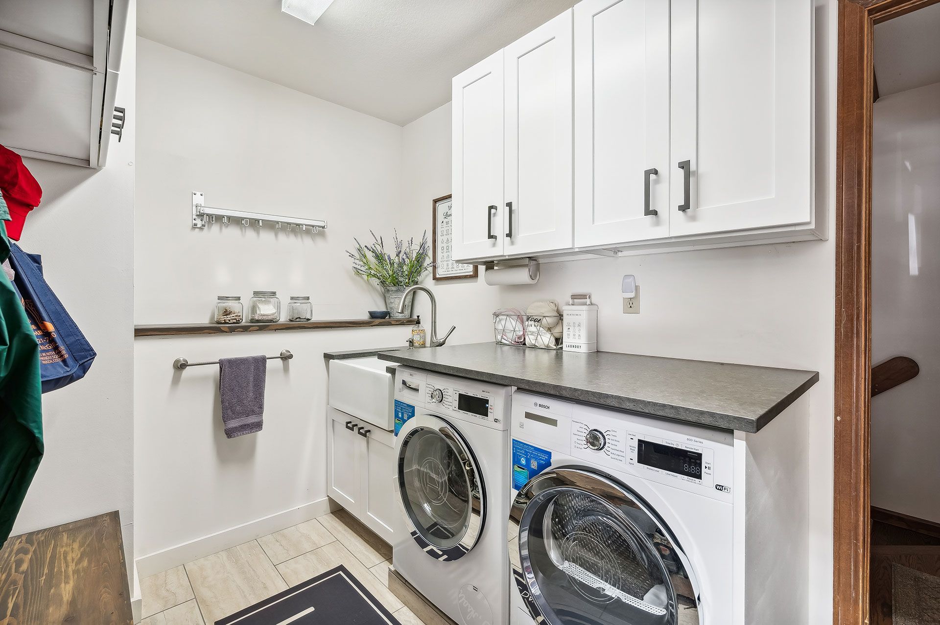 A laundry room with a washer and dryer and a sink.