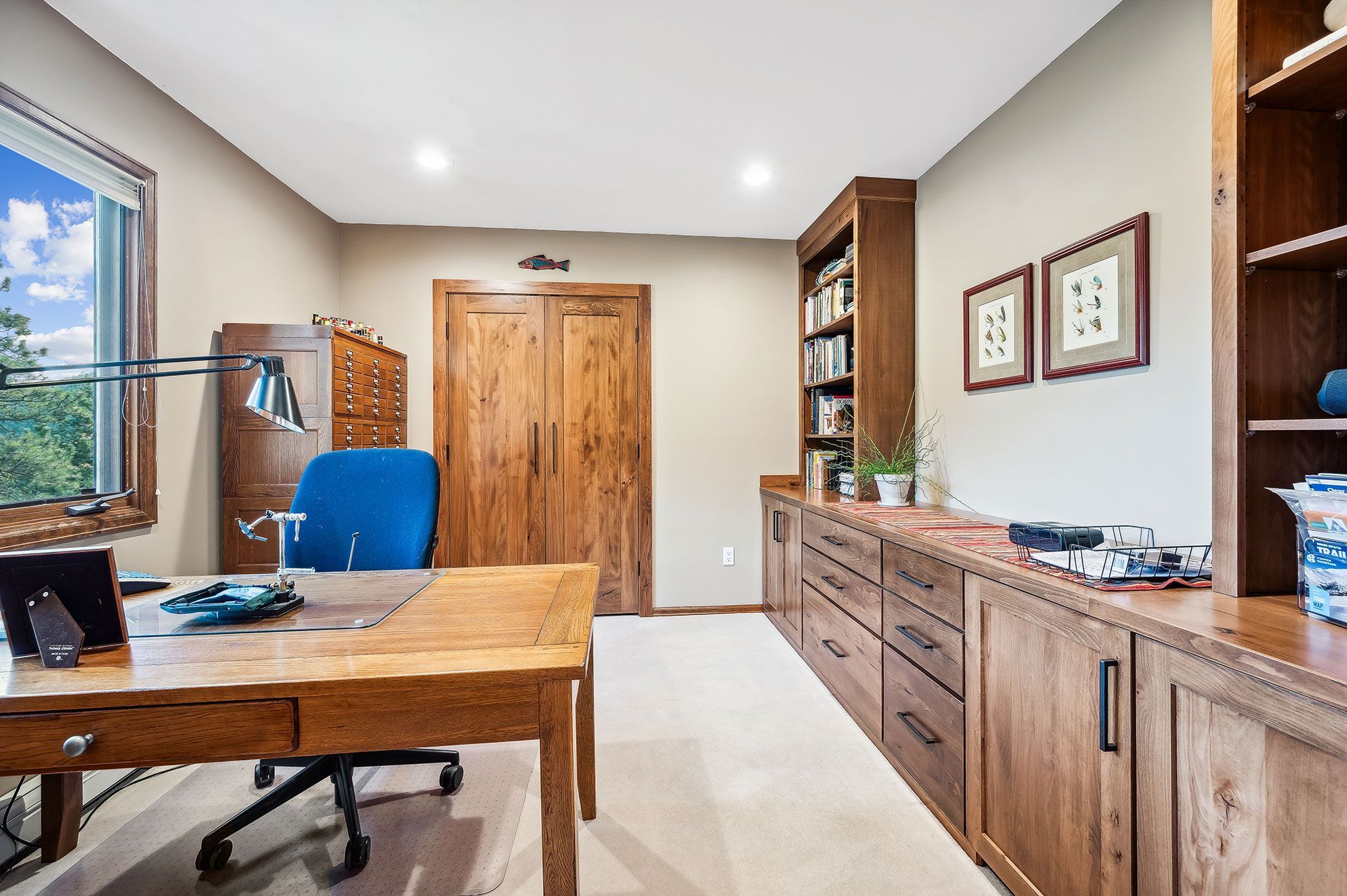 A home office with a wooden desk and chair.