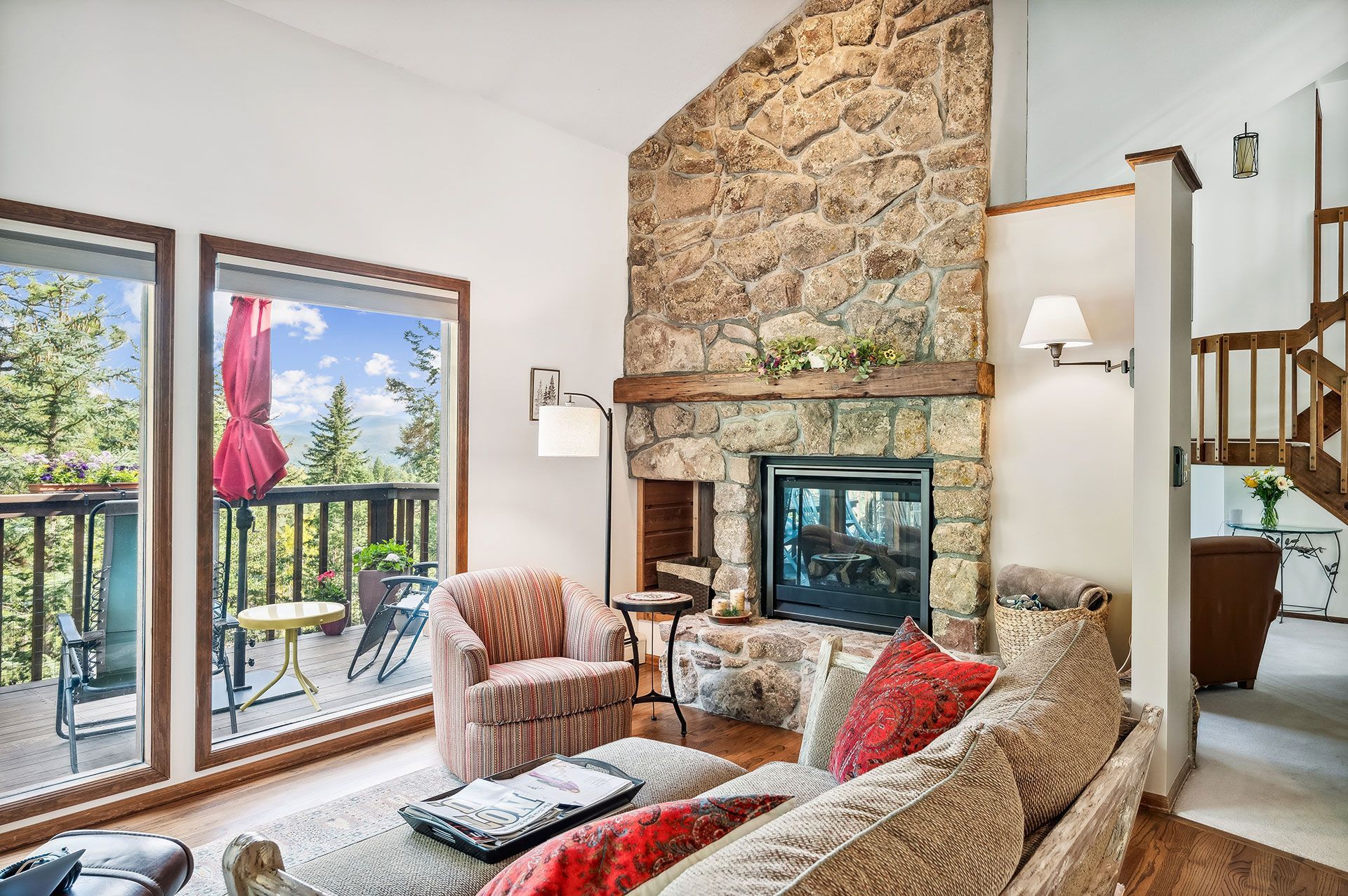 A living room with a couch , chair , and fireplace.