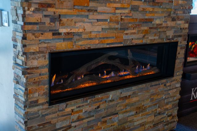Patio with fire pit, pool, and city view at dusk. Modern home exterior with warm lighting.