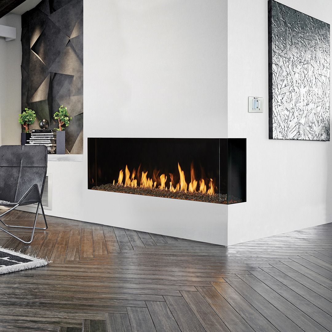 Modern corner fireplace with flames, dark surround, set in white walls, wooden floor.