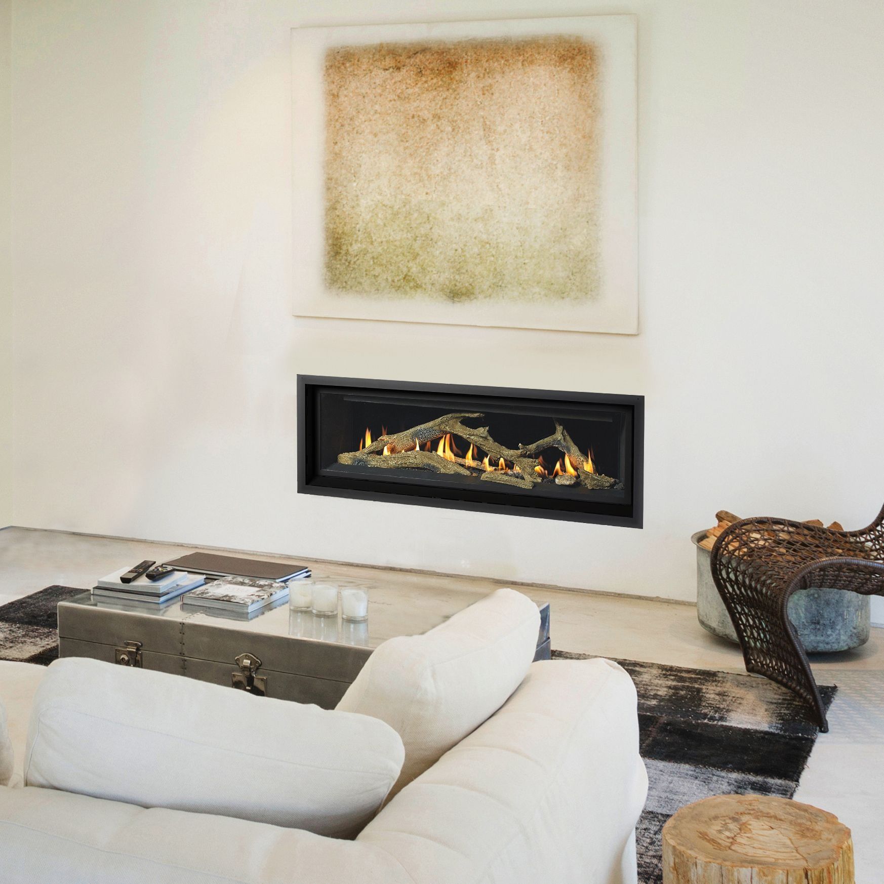 Modern living room with fireplace, white sofa, coffee table, and abstract art.