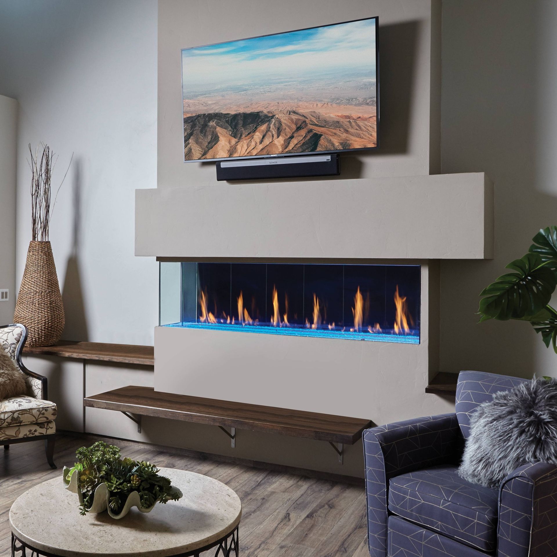 Modern living room with a linear gas fireplace, TV above it, and seating.