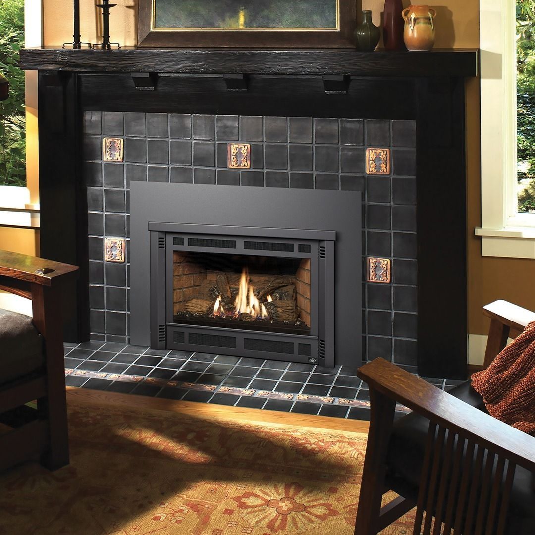 Fireplace with black tiled surround, decorative tiles, and wooden mantel.