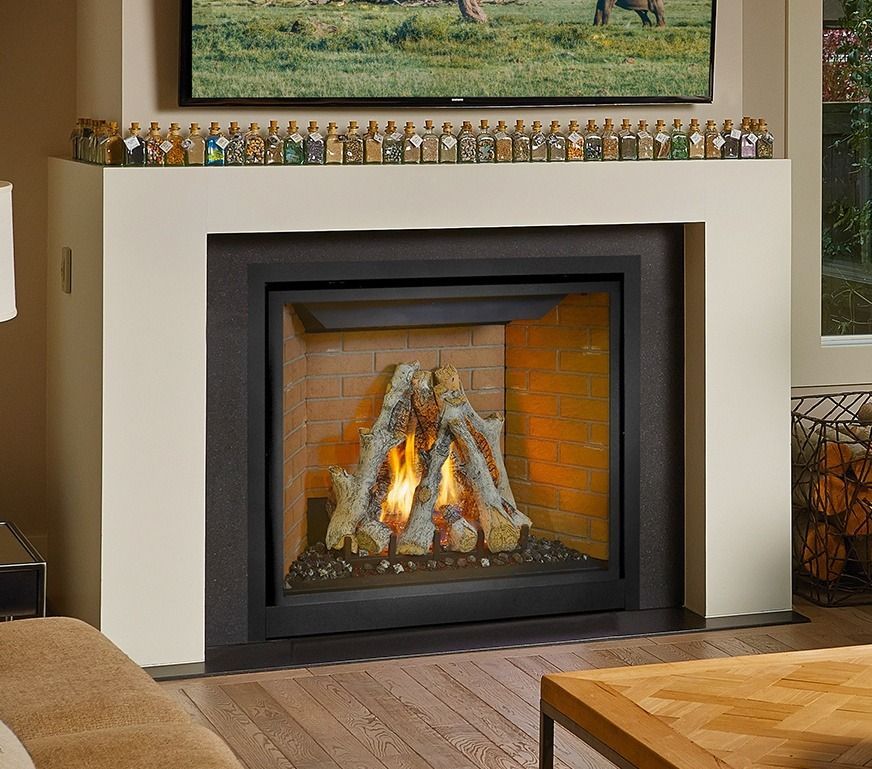 Fireplace with burning logs, brick interior, black surround, and white mantle.