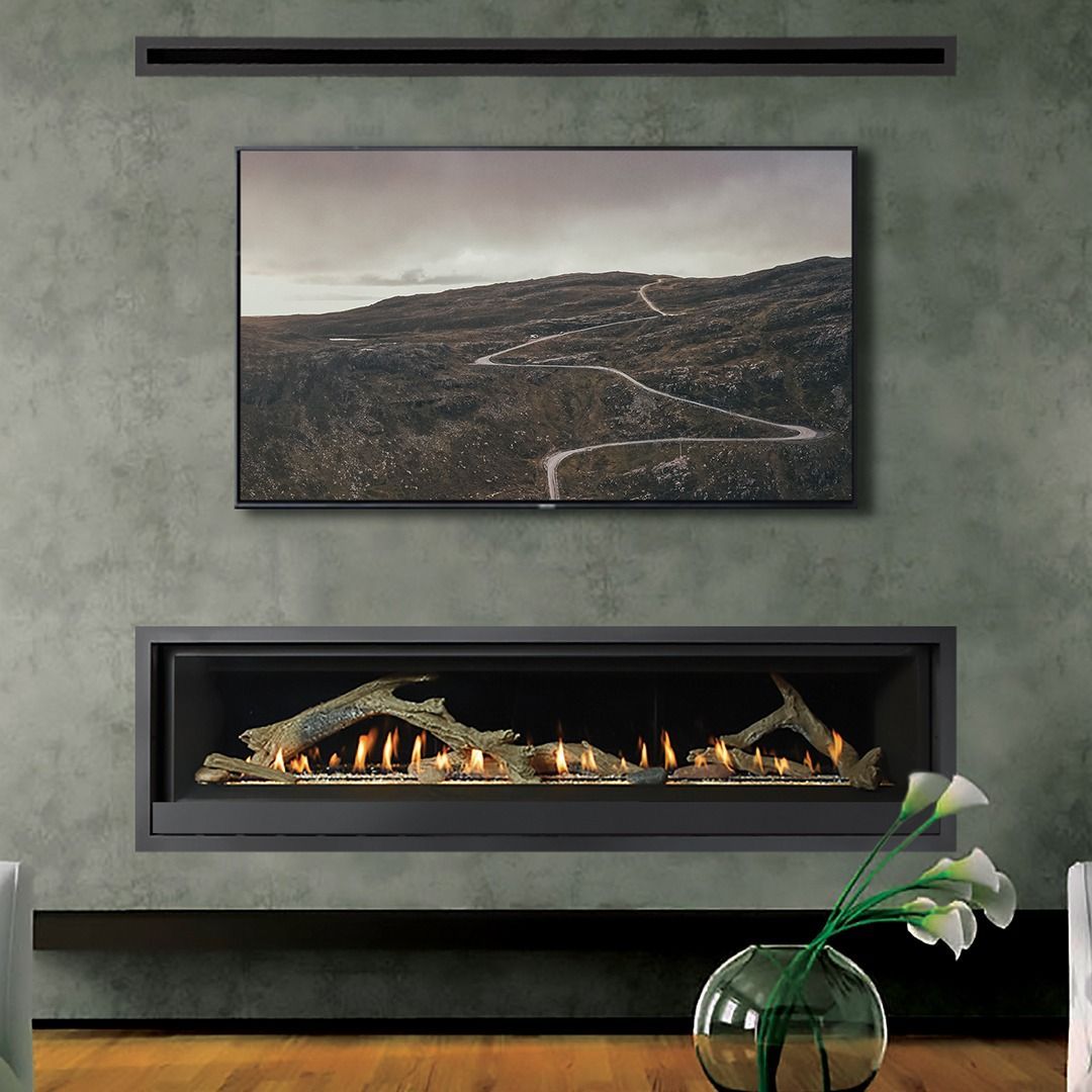 Modern fireplace with artwork above, flowers in vase in front.