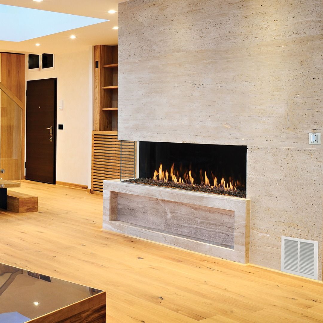 Modern living room with a stone fireplace, wood floors, and built-in shelving.