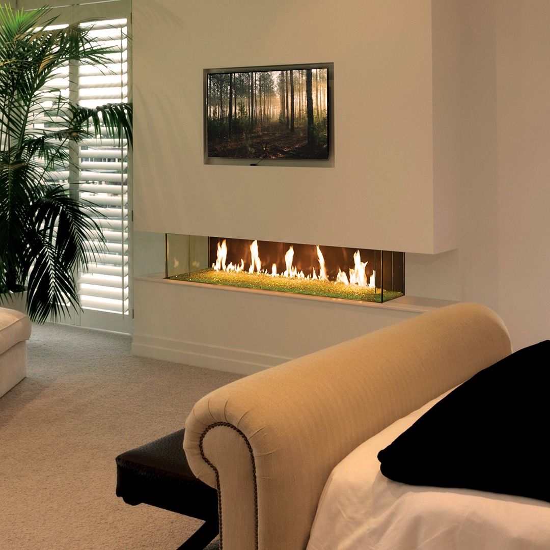 Modern fireplace with flames, built into a white wall, with a TV above.