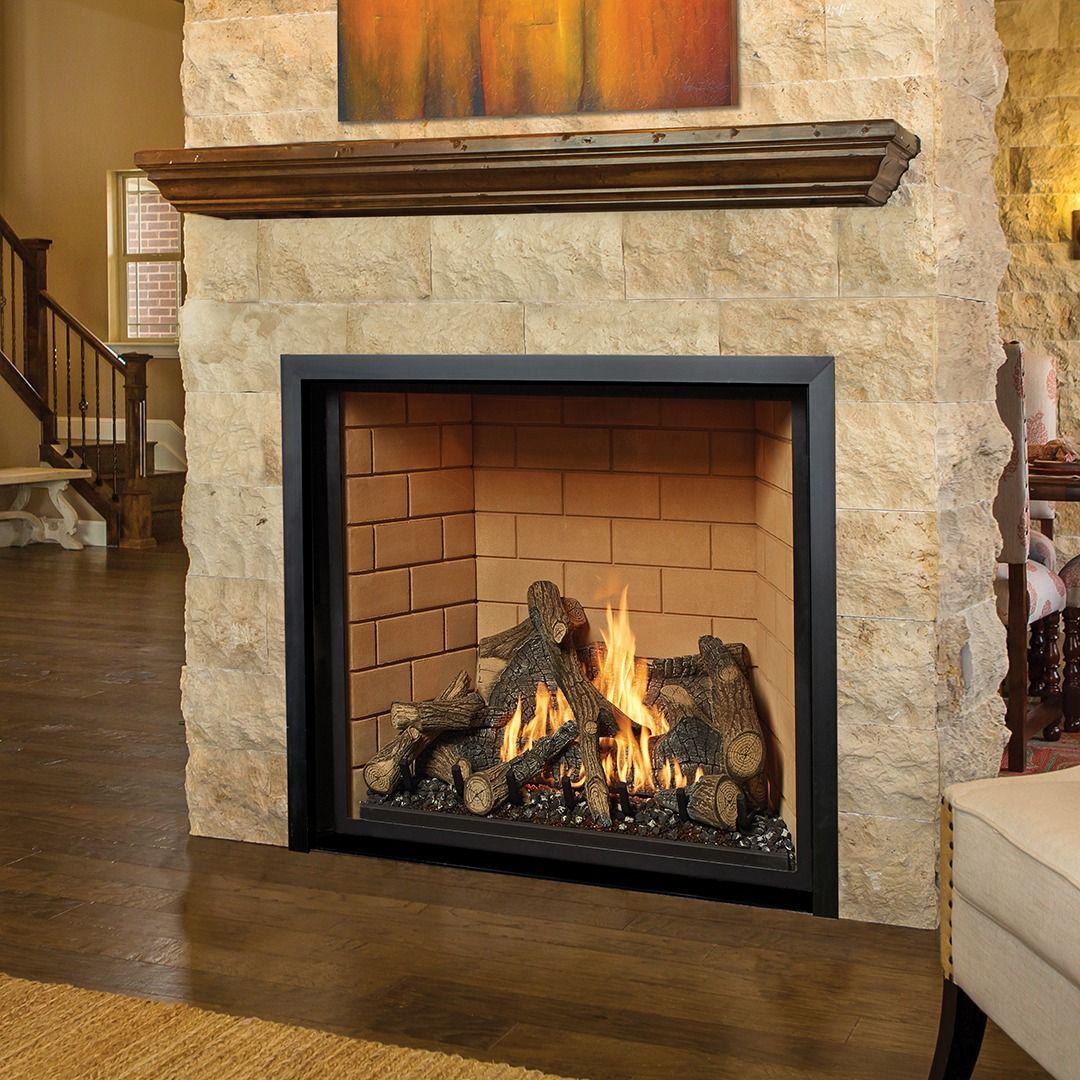 Fireplace with burning flames, dark rocks, and a stone facade. Wooden mantle above.
