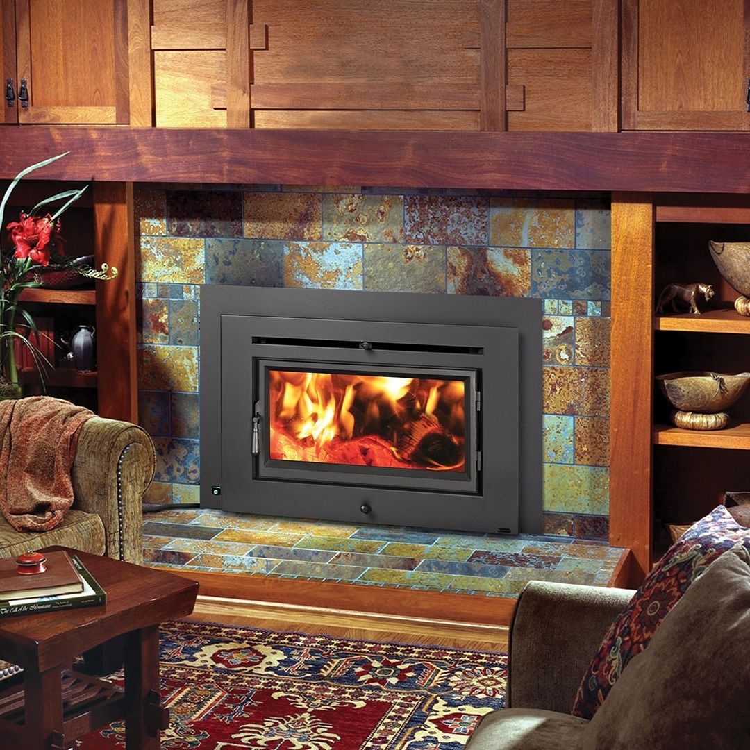 Fireplace with burning fire, set in a tiled stone hearth. Wooden mantle, built-in shelving, cozy interior setting.