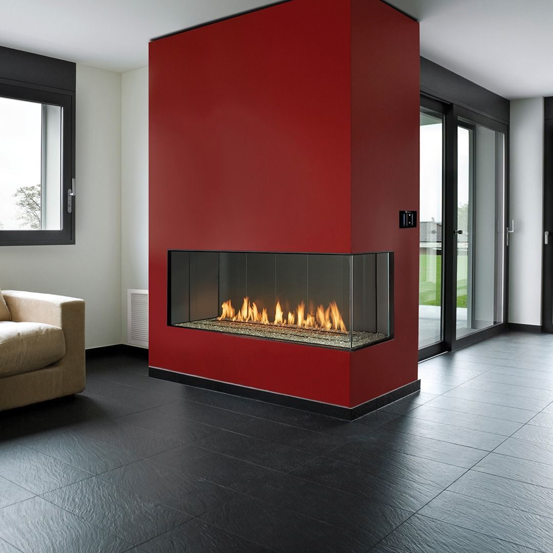 Red fireplace with flames, built into a red wall, with black flooring, in a modern home.