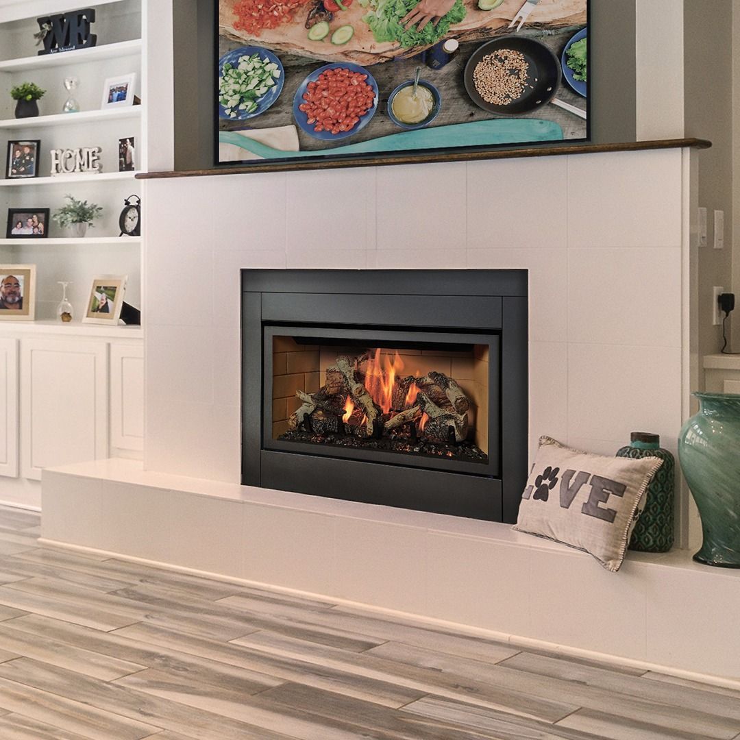 Fireplace with flames, white mantel, artwork above. Shelf with decor to the left, floor with wood-look tile.