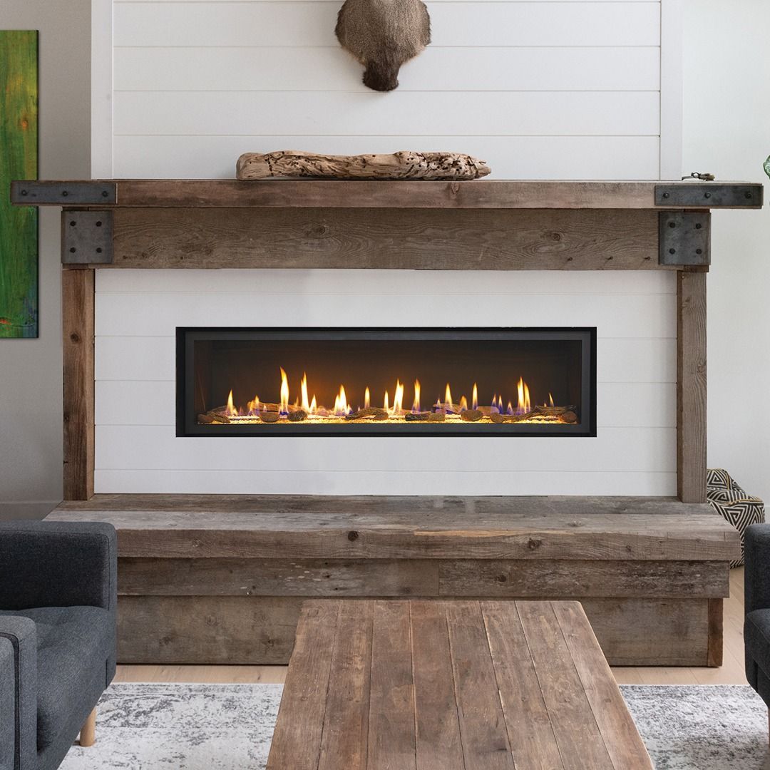 Fireplace with wooden mantel, flame lit.
