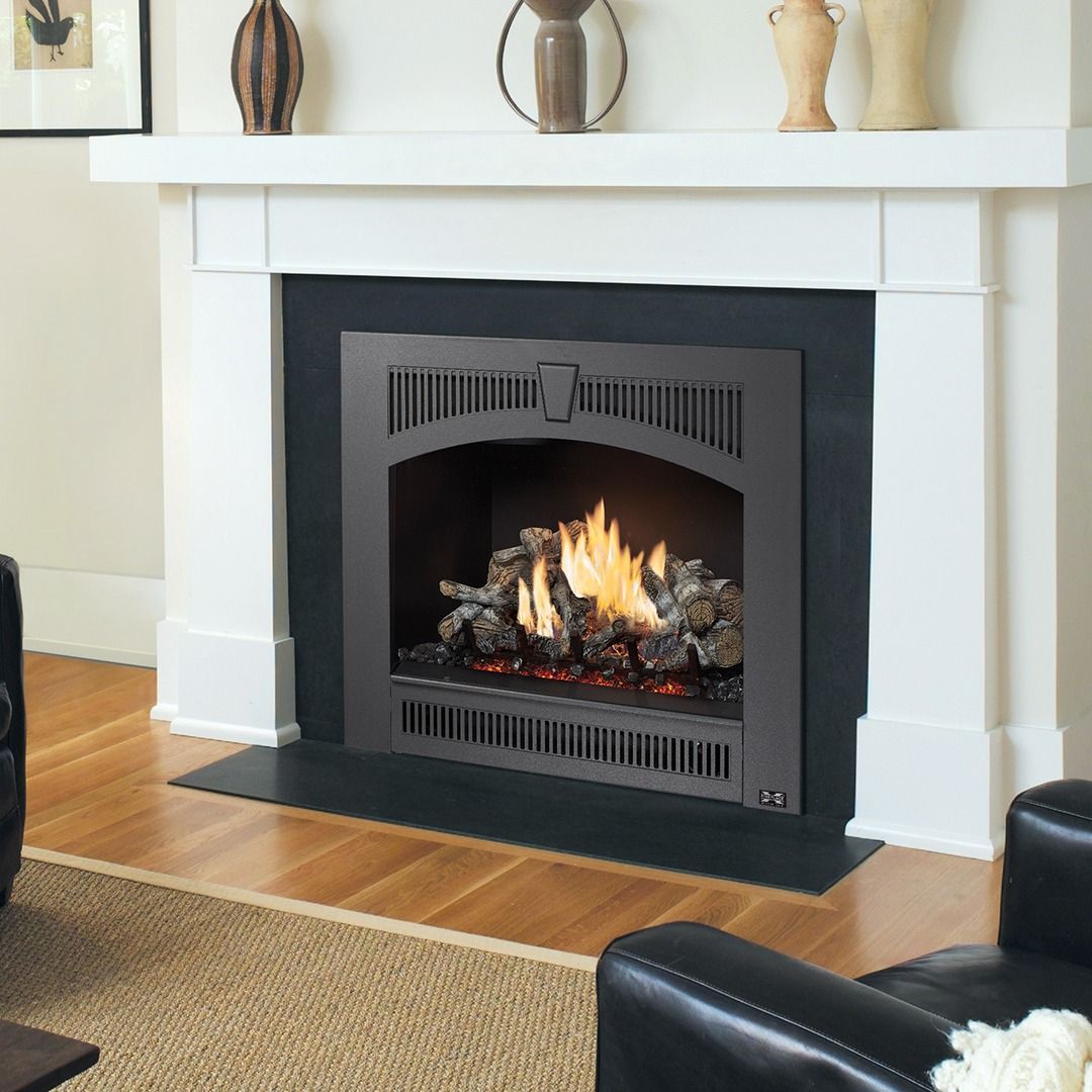 Gas fireplace with flames burning, set in a white mantel.