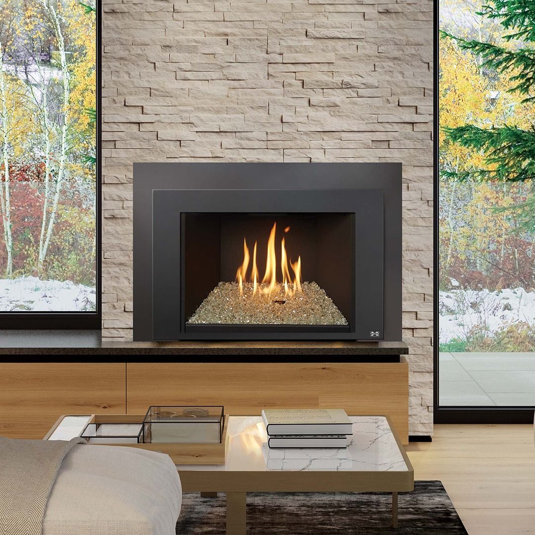 Modern fireplace with flames, gray stone wall, and a living room setting with windows.
