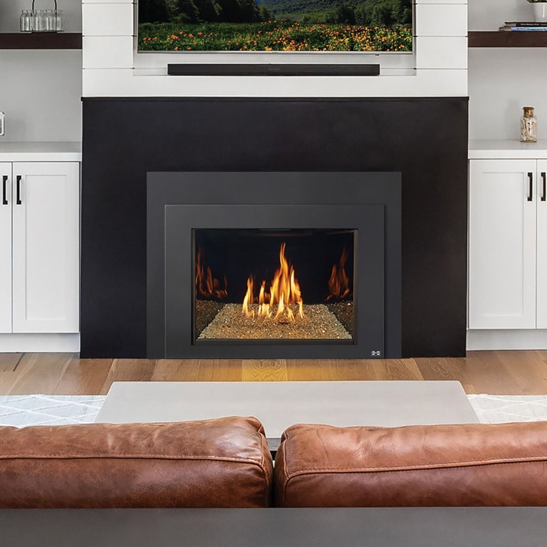 Modern living room with fireplace, white cabinets, and brown leather couch.