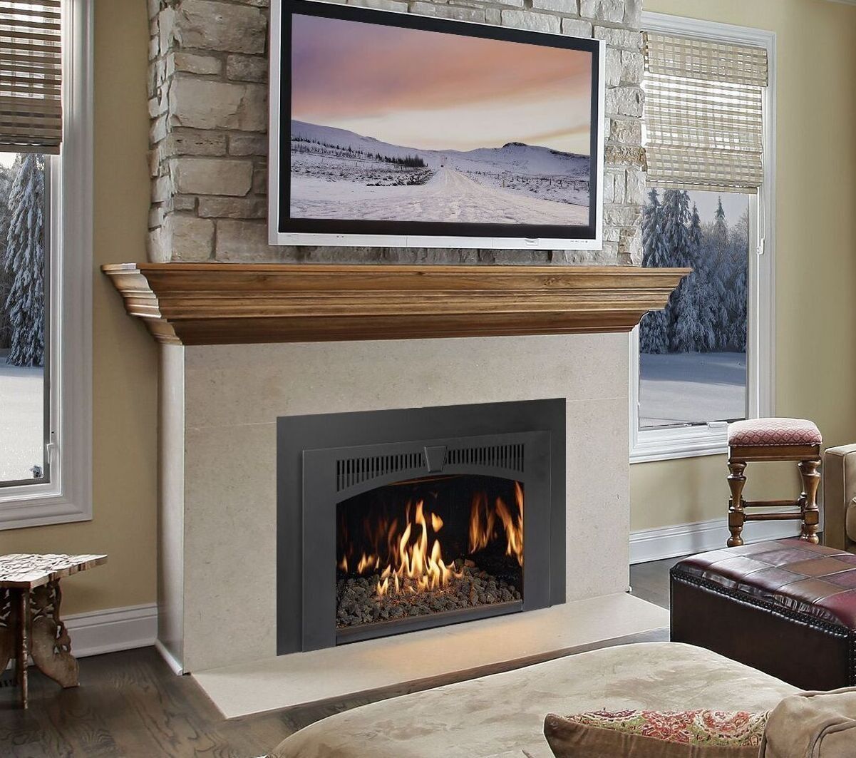 Fireplace with flames and mounted TV, set in a living room with stone and wood accents.