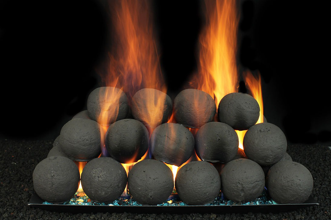 Charcoal briquettes stacked and burning, with orange flames against a black background