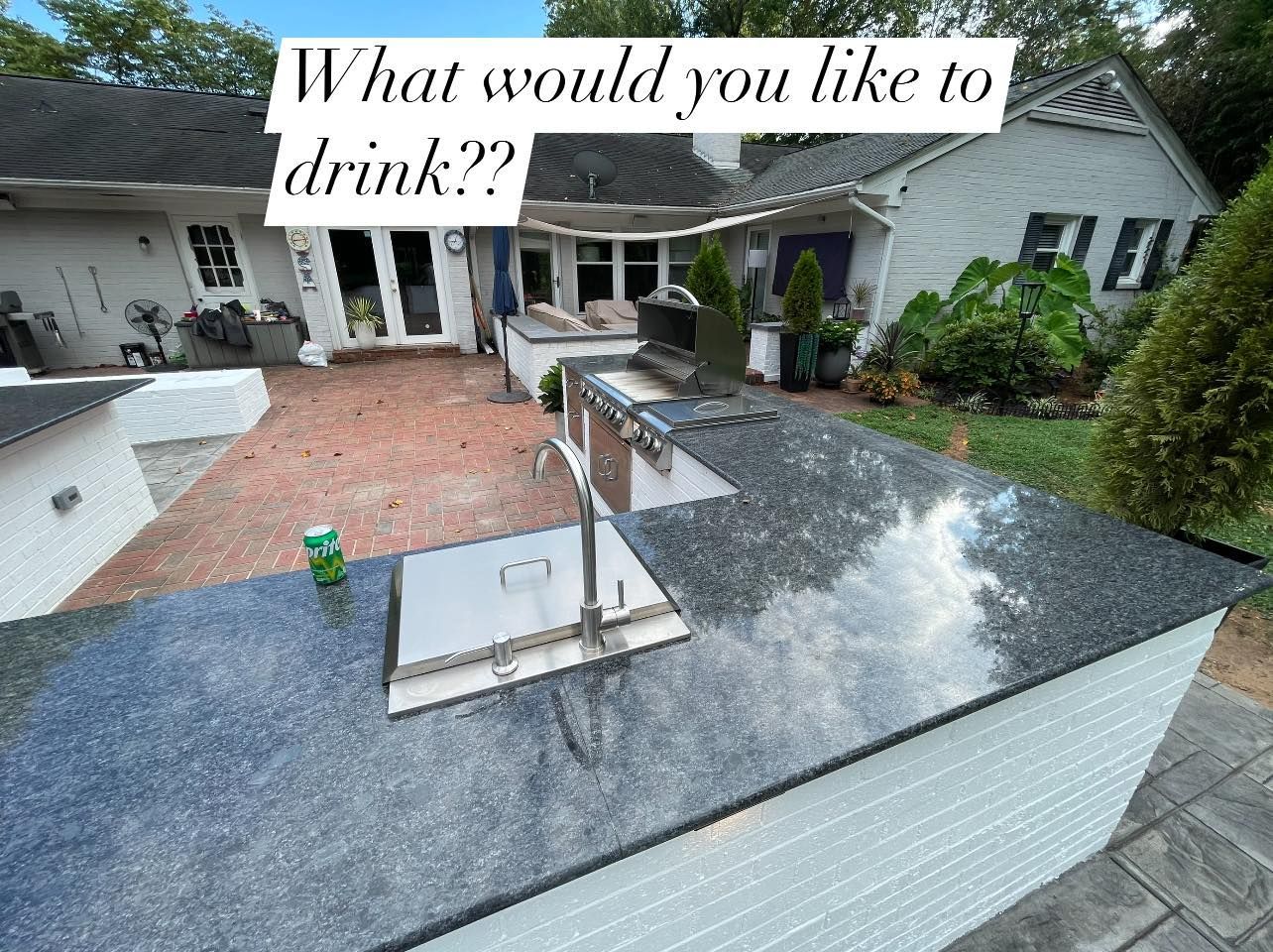 A kitchen counter with a can of soda on it in front of a house.