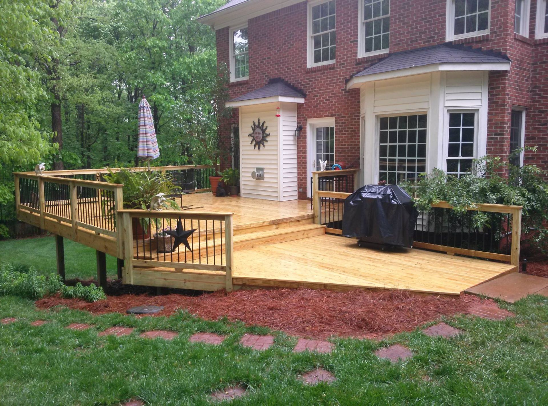A brick house with a wooden deck in front of it