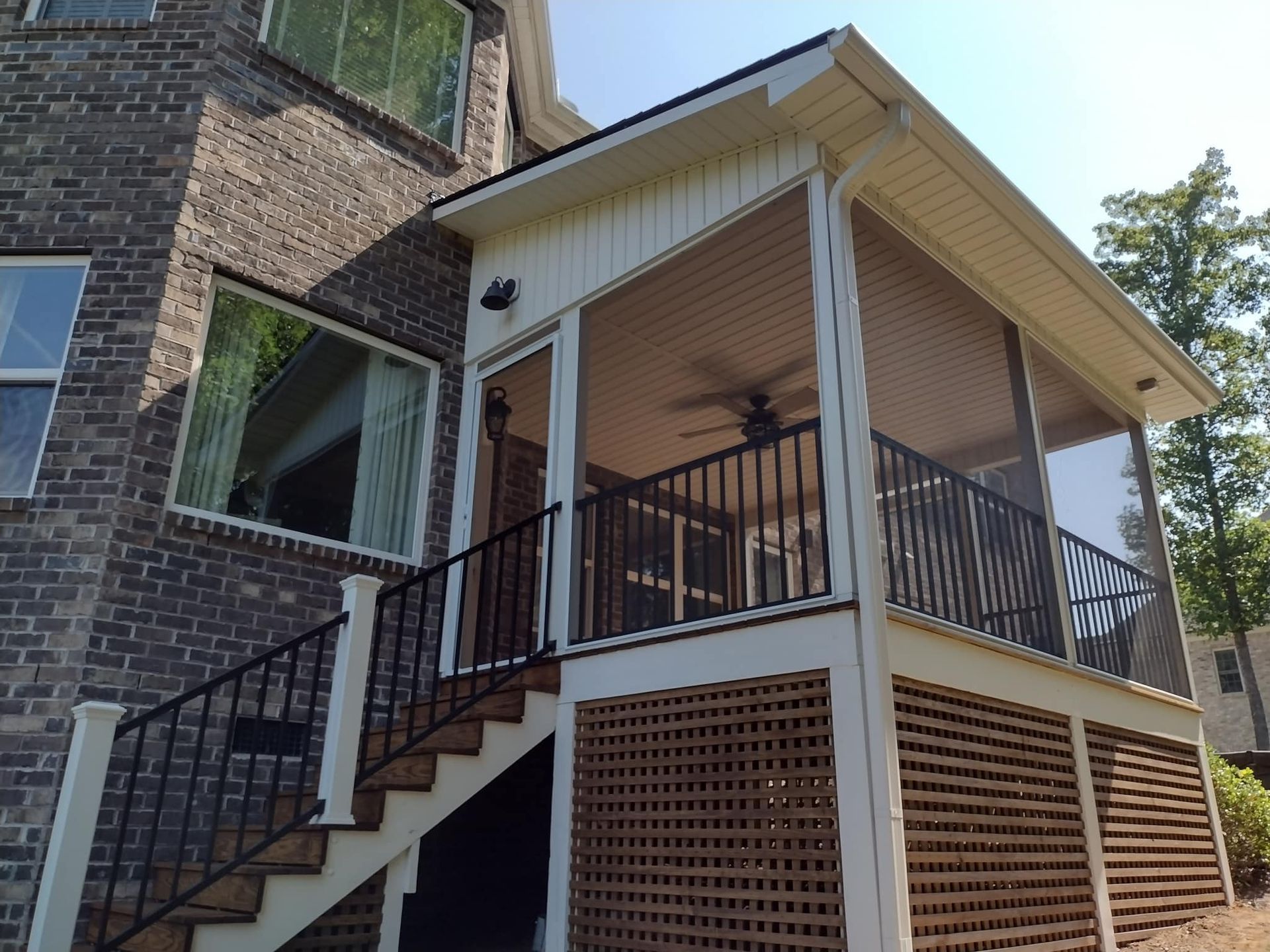 A screened in porch with stairs leading up to it
