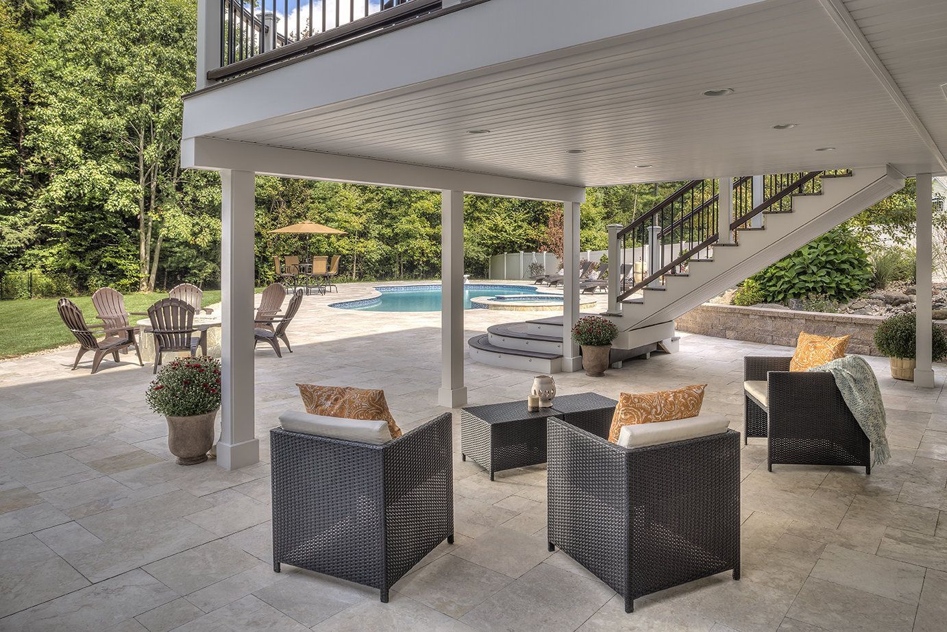 A garden with flowers and stairs in front of a brick house