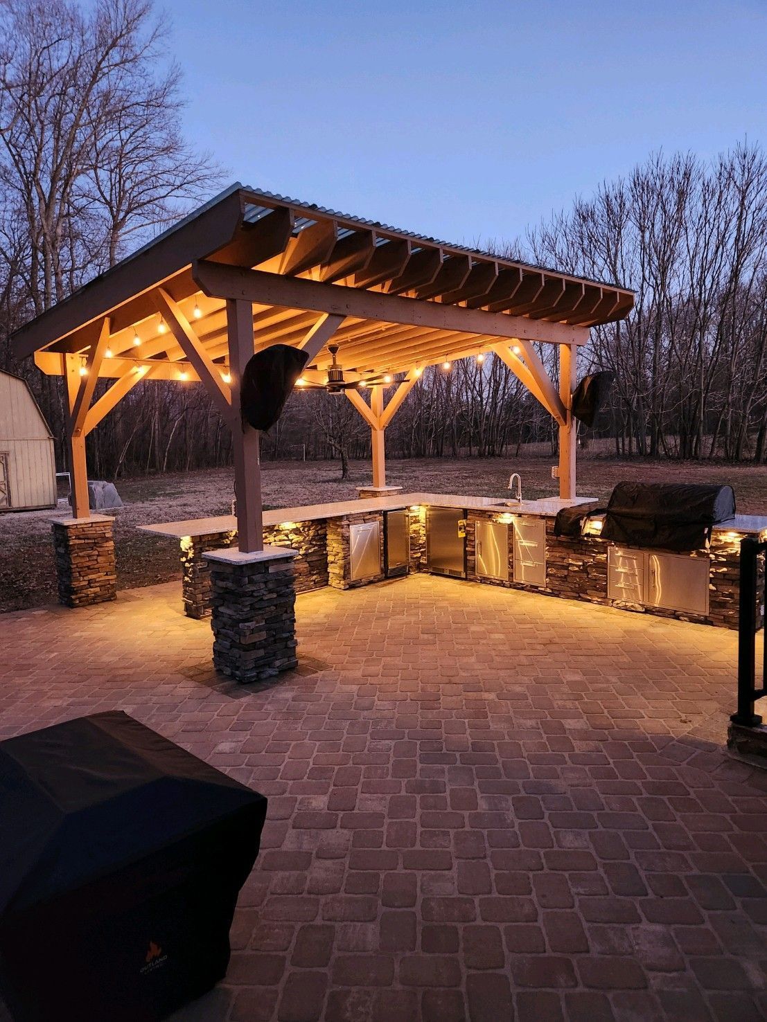 A patio with chairs and a hot tub in the backyard