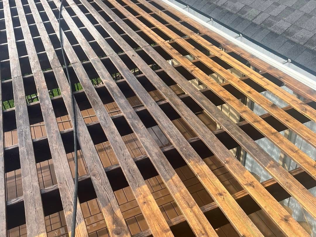 Sunlit metal grating walkway with alternating rusted and silver bars, viewed at an angle