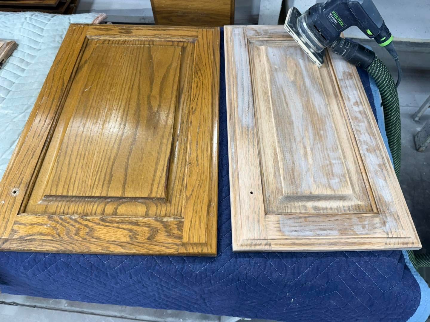 Two cabinet doors side by side on a blue cloth, one dark wood and one stripped lighter wood.