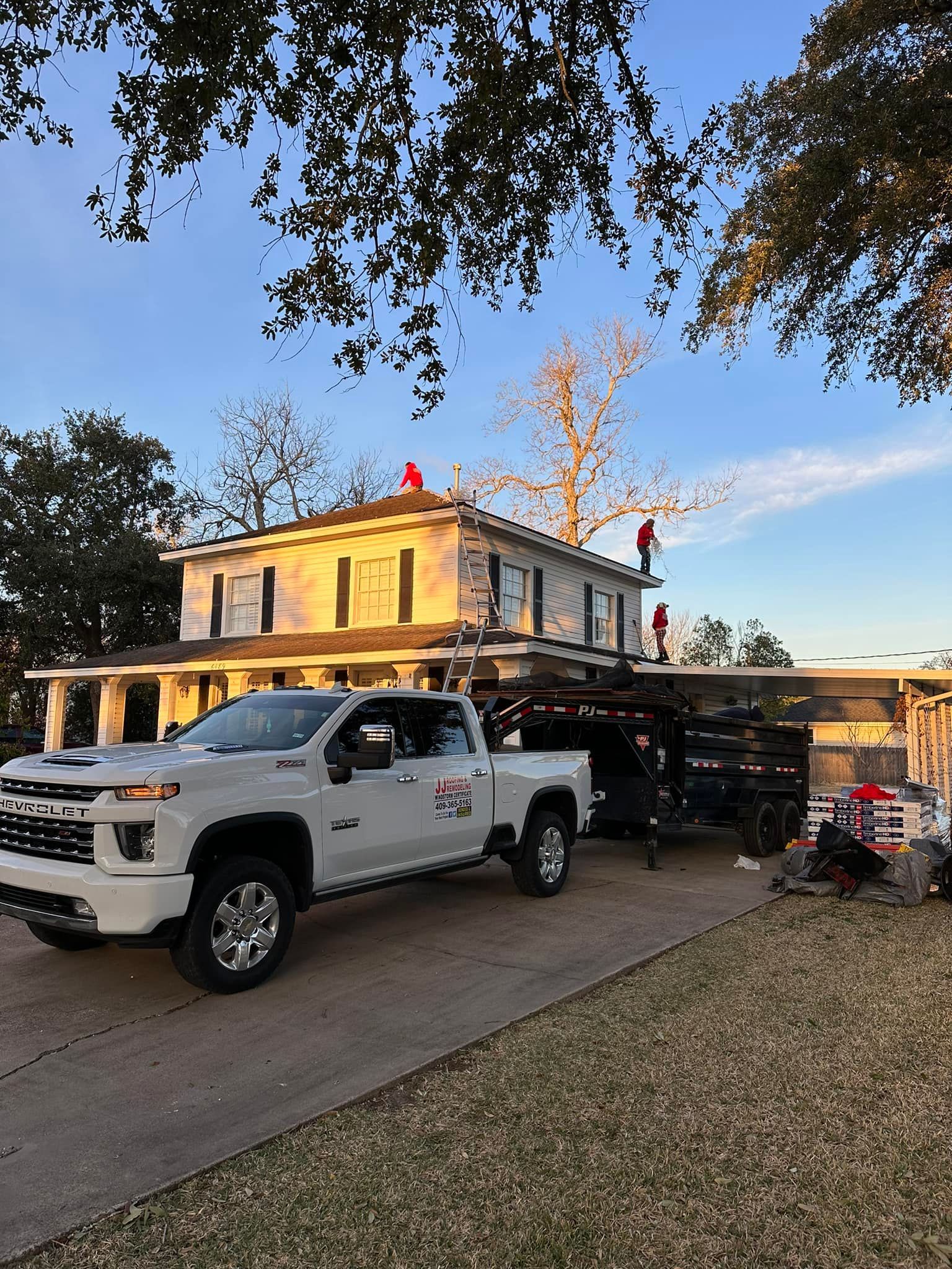a white truck is parked in front of a large house .