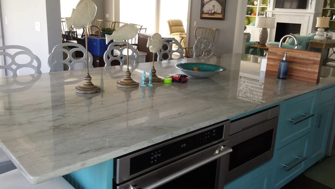 A kitchen with a large island and stainless steel appliances