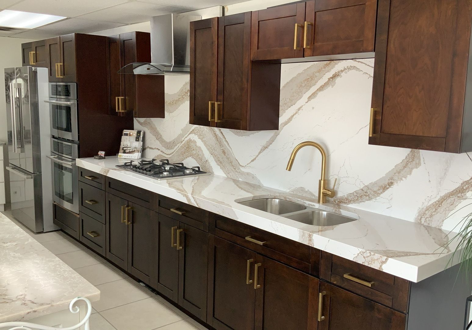 A kitchen with stainless steel appliances and wooden cabinets.