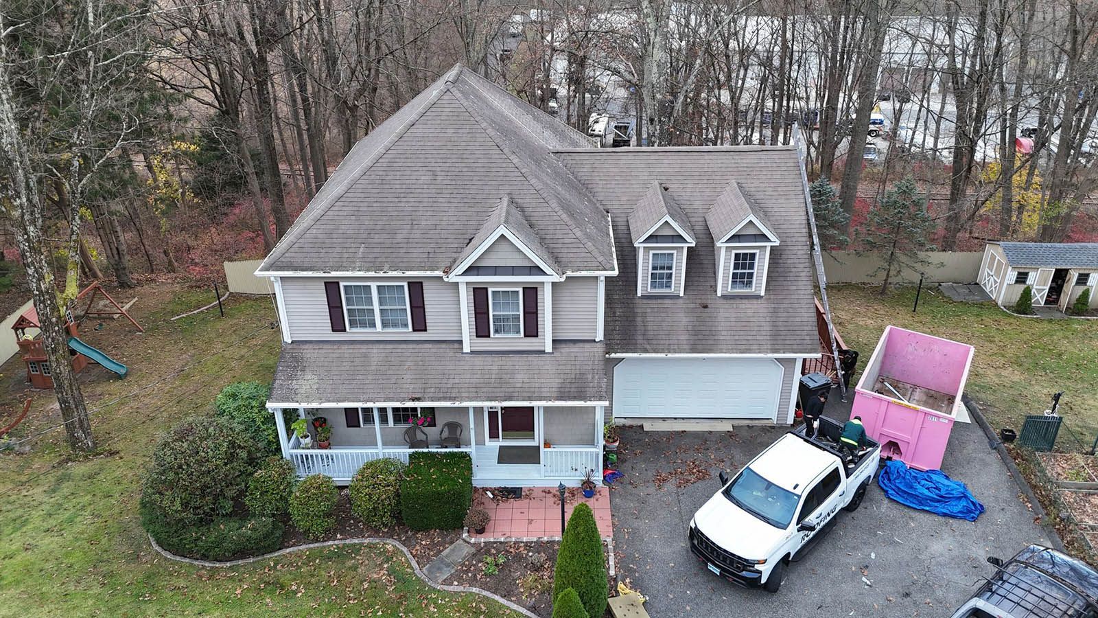 An aerial view of a house with a truck parked in front of it