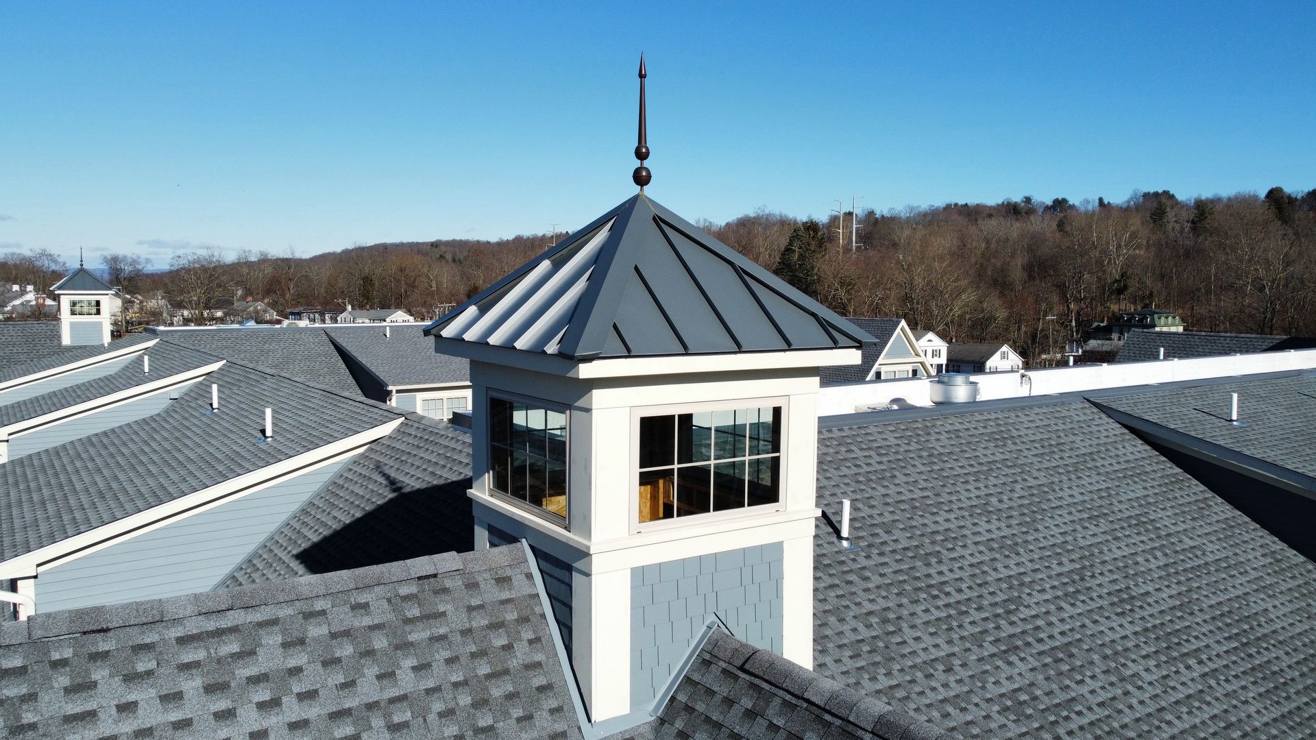 An aerial view of a roof with a tower on top of it.