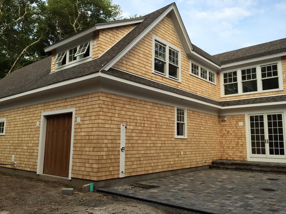 A large house with a garage and a lot of windows