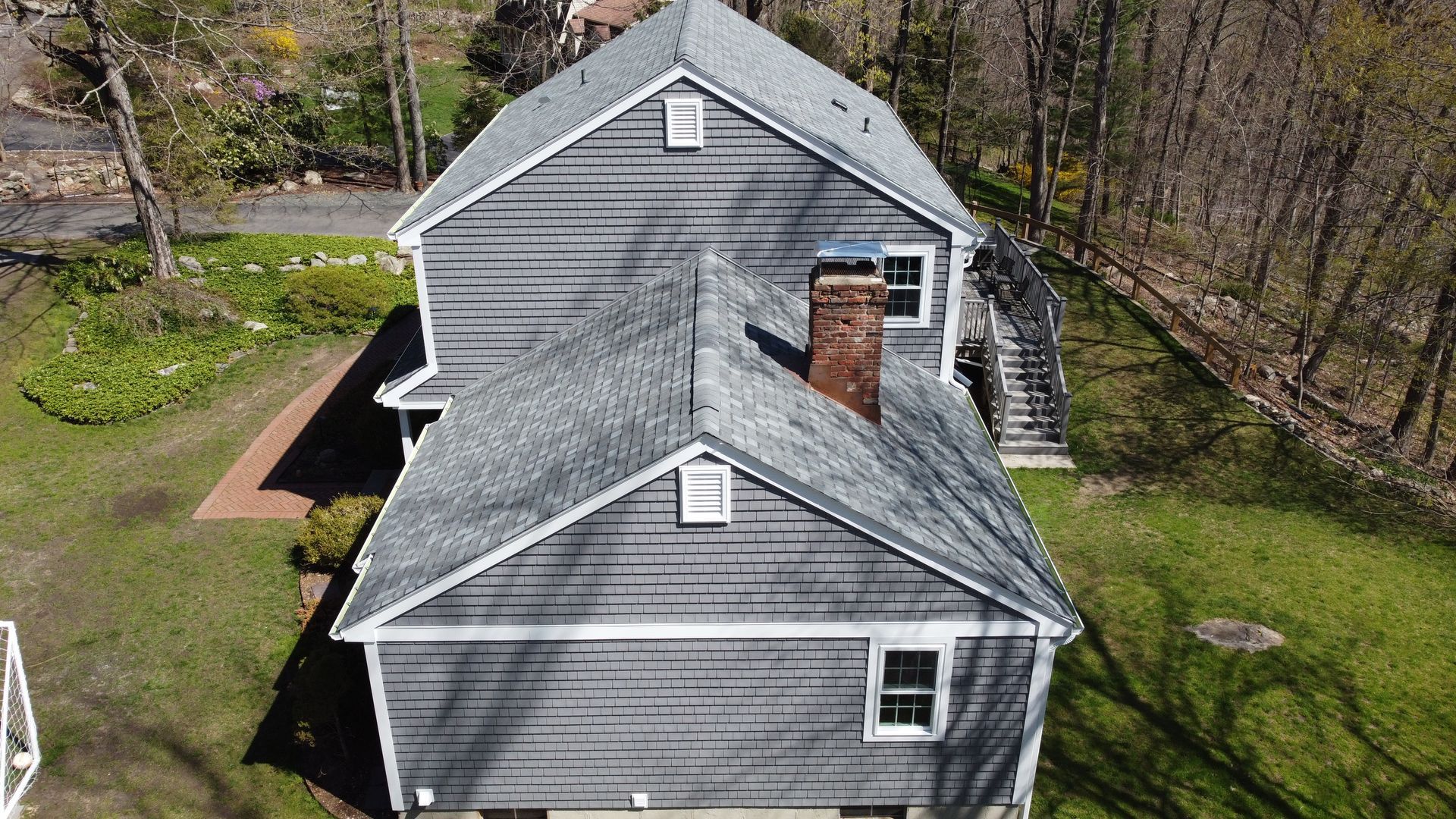 An aerial view of a house with a chimney on the roof.
