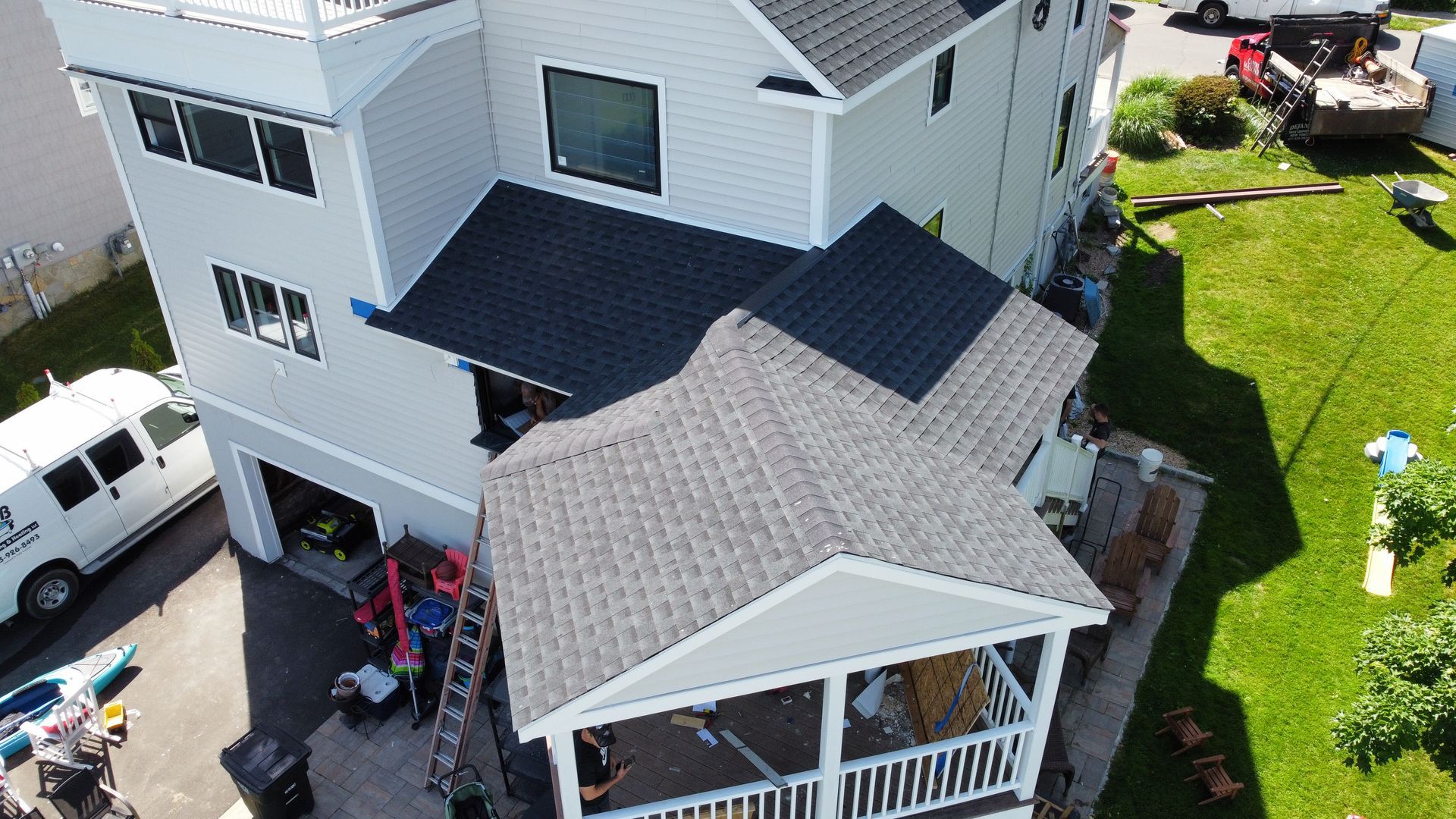 An aerial view of a house with a roof that is being installed.
