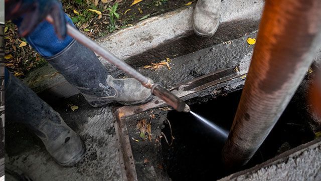 1a man drain cleaning a commercial property