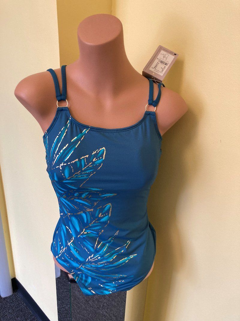 A mannequin is wearing a blue tank top