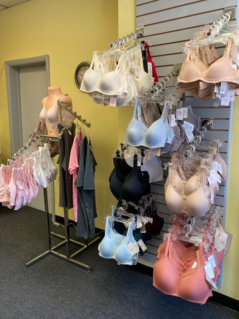 A bunch of bras are hanging on a rack in a store.