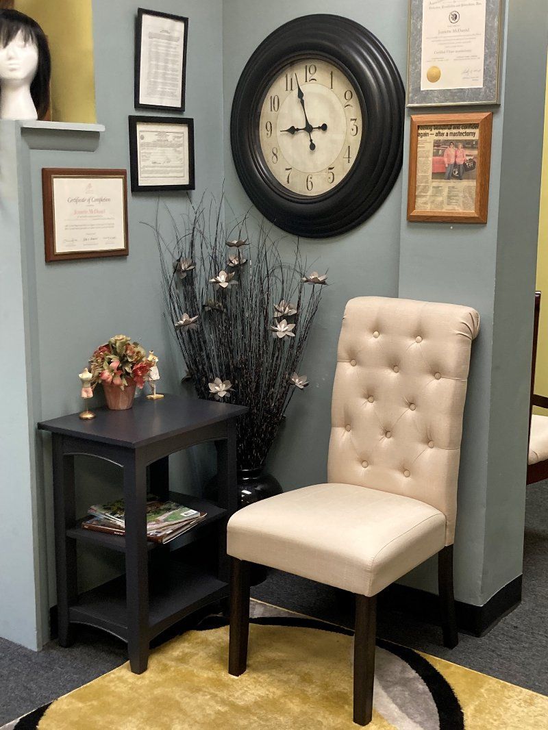 A room with a chair and a clock on the wall