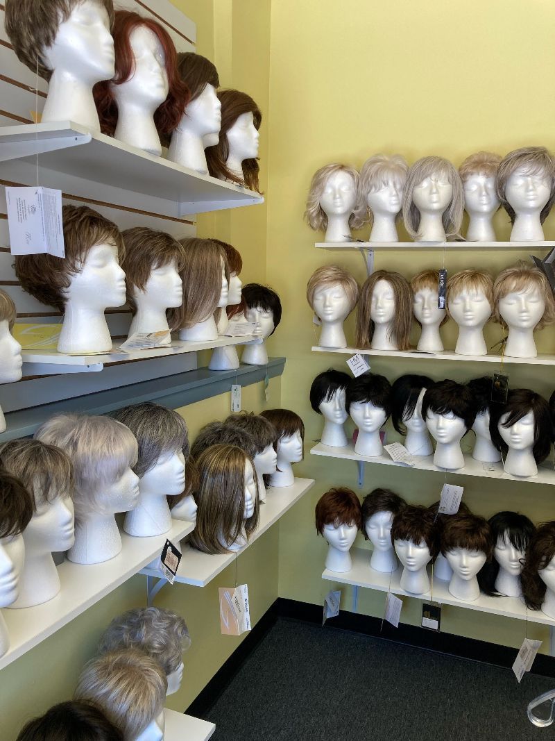 A room filled with lots of wigs on shelves
