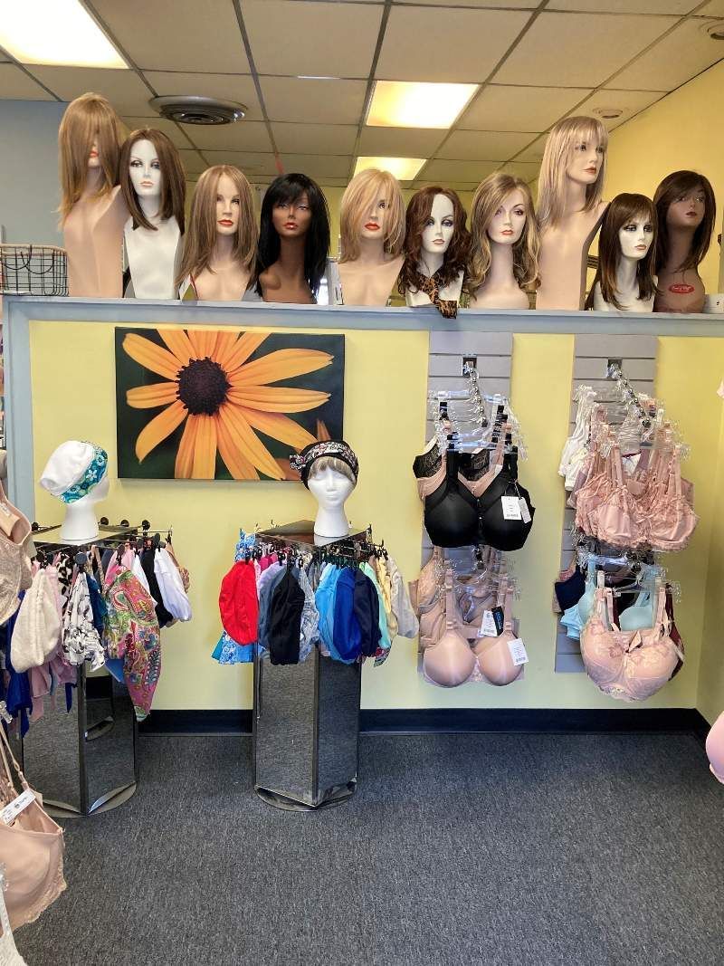 A room filled with lots of mannequins and wigs.