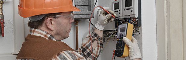 An electrician testing electric meter