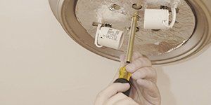An electrician repairing bulb wiring
